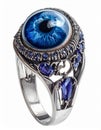 Silver Ring Featuring a Blue Glass Eye and Sapphire Accents on a White Background Royalty Free Stock Photo