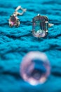 Silver ring with a large stone mystical topaz on a knitted blue table Royalty Free Stock Photo