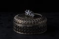A silver ring lies on a silver box. Silver ring in the form of flowers. Antique silver box.