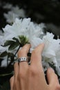 Silver ring and the white flowers in the background