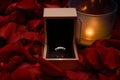 Silver ring in a wooden box on the table in the middle of rose petals Royalty Free Stock Photo