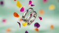 Silver rings with gemstones and falling petals Royalty Free Stock Photo