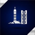 Silver Rocket launch from the spaceport icon isolated on dark blue background. Launch rocket in space. Vector Royalty Free Stock Photo