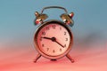 Silver shiny alarm clock in retro vintage style on blue red neon background. Minimal modern style Royalty Free Stock Photo