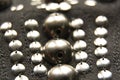 Silver shiny beads and sequins in vintage style are sewn on black coarse fabric Royalty Free Stock Photo