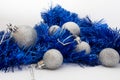 Silver shiny Christmas balls and shiny blue tape on white background Royalty Free Stock Photo