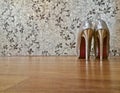 Silver shiny high-heeled shoes stiletto on wooden floor Royalty Free Stock Photo