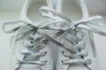 Silver shiny laces on white close-up sneakers Royalty Free Stock Photo