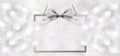 Silver shiny ribbon bow on blurred background