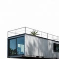 Silver Shipping Container Home Exterior with Metal Railing and Green Plant Royalty Free Stock Photo