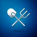 Silver Shovel and rake icon isolated on blue background. Tool for horticulture, agriculture, gardening, farming. Ground