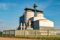 Silver silos on agro manufacturing plant for processing drying cleaning and storage of agricultural products, flour, cereals and Royalty Free Stock Photo