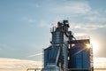 Silver silos on agro manufacturing plant for processing drying cleaning and storage of agricultural products, flour, cereals and Royalty Free Stock Photo