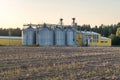 Silver silos on agro manufacturing plant for processing drying cleaning and storage of agricultural products, flour, cereals and Royalty Free Stock Photo