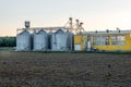 Silver silos on agro manufacturing plant for processing drying cleaning and storage of agricultural products, flour, cereals and Royalty Free Stock Photo