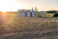 Silver silos on agro manufacturing plant for processing drying cleaning and storage of agricultural products, flour, cereals and Royalty Free Stock Photo