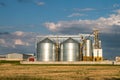 Silver silos on agro manufacturing plant for processing drying cleaning and storage of agricultural products, flour, cereals and Royalty Free Stock Photo