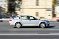 Silver Skoda Octavia Mk3 car third generation driving on high speed on asphalt city street, side view