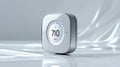 Silver smart home device with digital display showing temperature reading on a white background Royalty Free Stock Photo