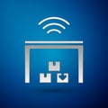 Silver Smart warehouse system icon isolated on blue background. Vector