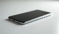 Silver smartphone placed on white surface. Sleek device shows black screen. Modern tech product isolated. High angle shot creates Royalty Free Stock Photo