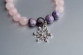 Silver snowflake on amethyst bracelet Royalty Free Stock Photo