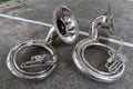 Silver sousaphone bass instrument for jazz band or marching band lies on the floor.