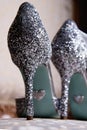 silver spangle shoes stand on the table, close-up kobluk, wedding details, bride wedding shoes Royalty Free Stock Photo