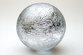 Silver sphere with a textured surface resting on a white background, creating a visually striking contrast Royalty Free Stock Photo