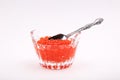 Silver spoon in a crystal dish with red caviar