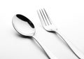 Silver spoon and fork on a white background. The spoon has a Royalty Free Stock Photo