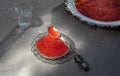 Silver spoon and plate with red caviar on gray Royalty Free Stock Photo