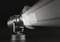 A silver spotlight emitting bright beams of light isolated on white background Royalty Free Stock Photo