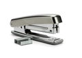 A silver stapler with a silver paper clip and a stack of paper clips Ai Generated Royalty Free Stock Photo