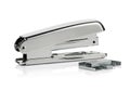 A silver stapler with a silver paper clip and a stack of paper clips Ai Generated Royalty Free Stock Photo