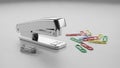 A silver stapler is positioned on a smooth light grey surface Royalty Free Stock Photo