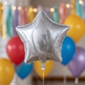 Silver star balloon with colorful balloons in background. Royalty Free Stock Photo