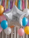 Silver star balloon with colorful balloons in the background. Royalty Free Stock Photo