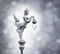 Silver statue of angel hold the lamp on the bokeh background Royalty Free Stock Photo