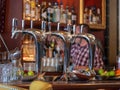 Silver steel beer taps with liquor and bartender Royalty Free Stock Photo