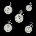 Silver stopwatches with white faces and black numerals are arranged against a dark Royalty Free Stock Photo
