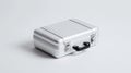 A silver suitcase sitting on top of a white surface Royalty Free Stock Photo
