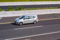 Silver Suzuki Ertiga driving fast on trans jawa highway Royalty Free Stock Photo