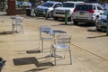 Silver table and chairs in front of the Municipal Market with parked cars in Atlanta Georgia