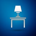 Silver Table lamp on table icon isolated on blue background. Vector