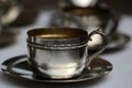 Silver tea cup with saucer