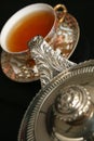 Silver teapot pouring tea Royalty Free Stock Photo