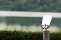 A silver telescope in a park