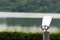 A silver telescope in a park