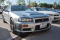 silver tenth generation Nissan Skyline GT R34 at a Japanese car meet